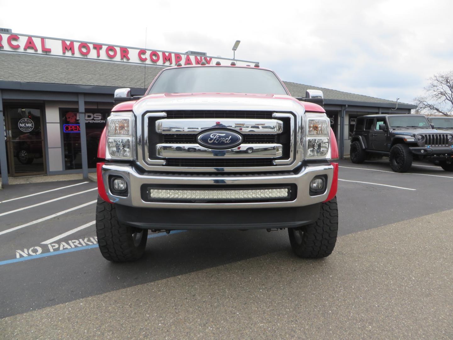 2014 Red /TAN Ford F450 Super Duty Crew Cab Lariat Crew Cab 4WD (1FT8W4DT7EE) with an V8 Turbo Diesel 6.7 Liter engine, Automatic 6-Spd w/SelectShift transmission, located at 2630 Grass Valley Highway, Auburn, CA, 95603, (530) 508-5100, 38.937893, -121.095482 - Wow!! 14 F450 sitting on Icon Vehicle Dynamics suspension, 24" American Force wheels, 37" tires, Rough Country back up leds, Light bar, Window tint, Smoked tail lights 3rd brake light, cab lights, and marker lights, Air bags with compressor, and train horns. Must see this head turner! - Photo#1